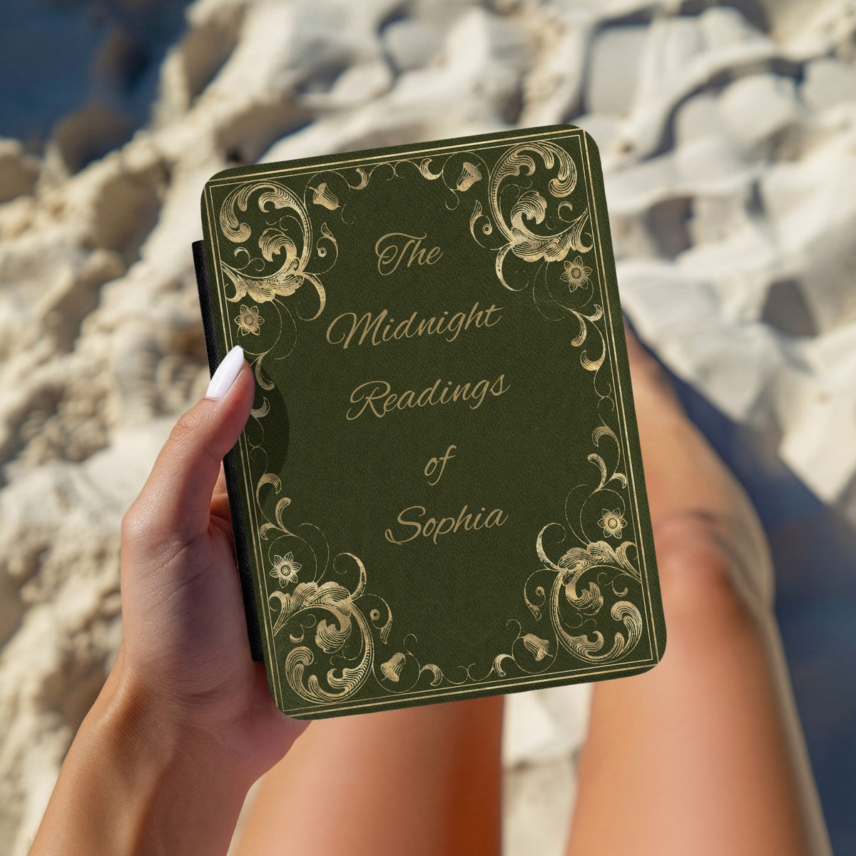 Hand holding a personalised Midnight Readings Kindle case outdoors