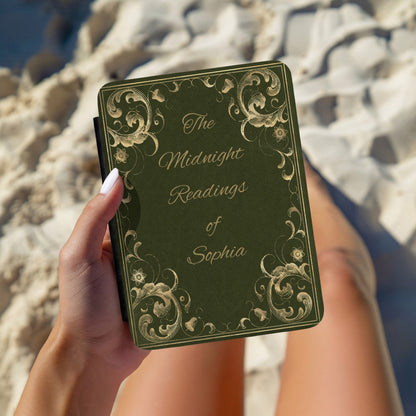Hand holding a personalised Midnight Readings Kindle case outdoors