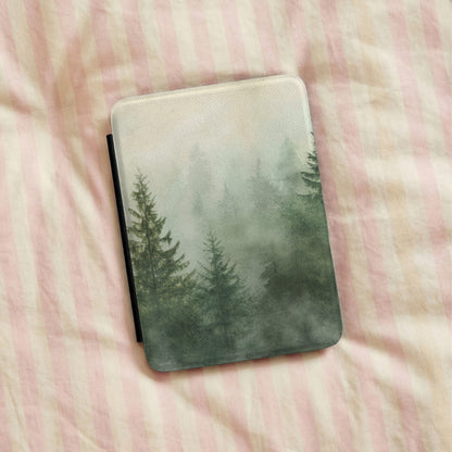 Misty Pine Forest Kindle case lying on pink striped bedding