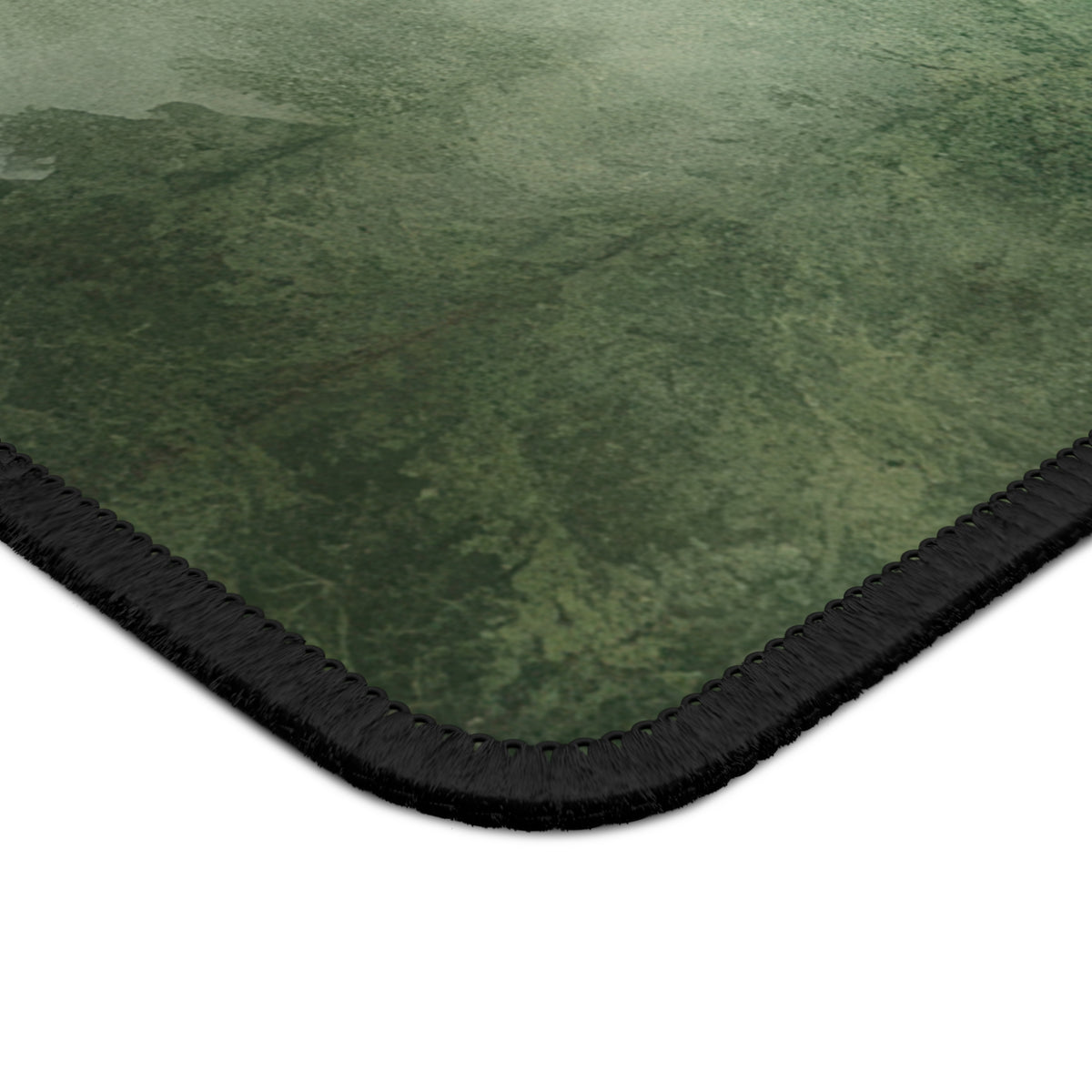 Close-up of the stitched edge of the Misty Pine Forest mouse mat