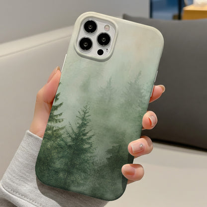 Misty Pine Forest tough phone case held in hand at a desk