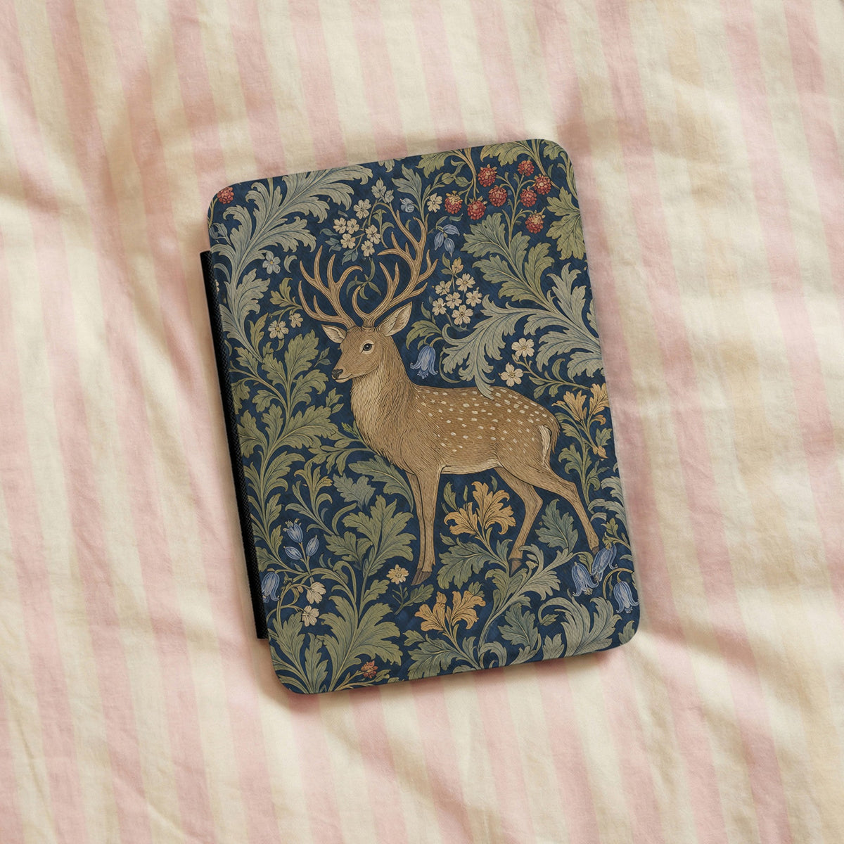 Morris Deer Kindle case on a striped bedspread