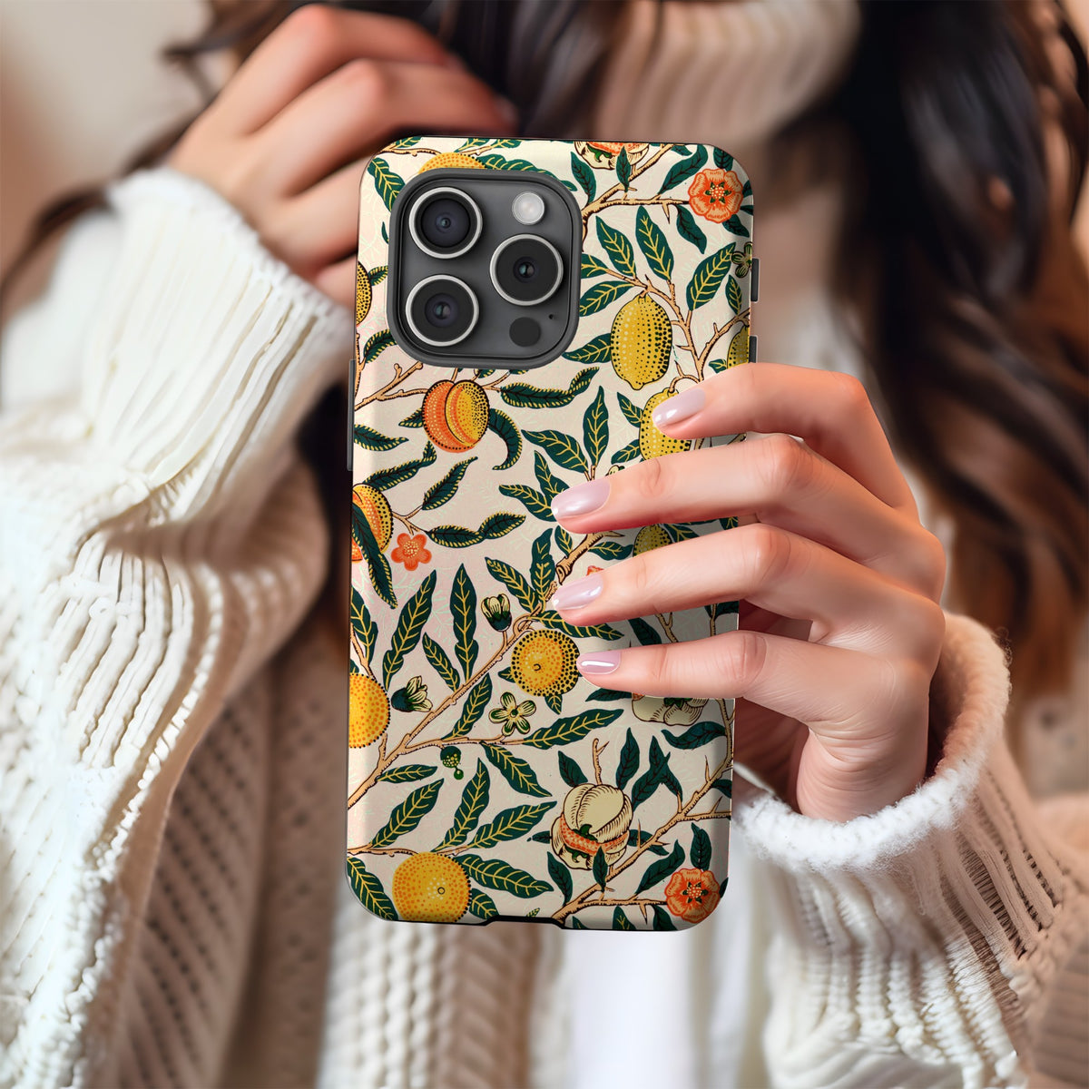 Morris Fruit tough phone case held against a cream knit sweater