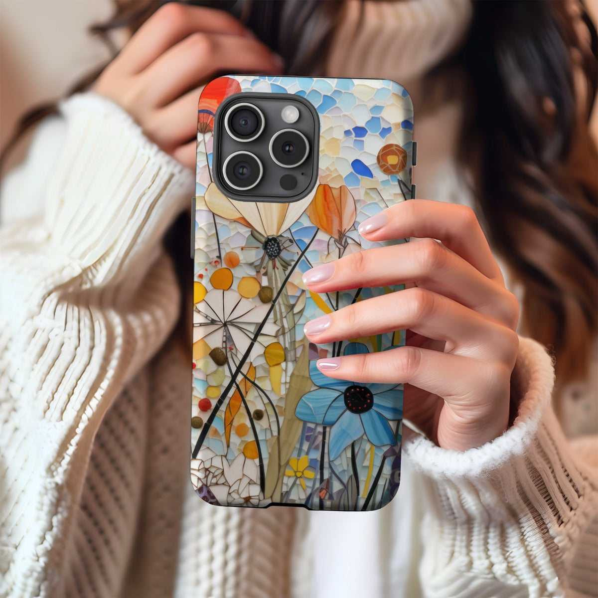 Woman holding a stained-glass wildflower MagSafe phone case
