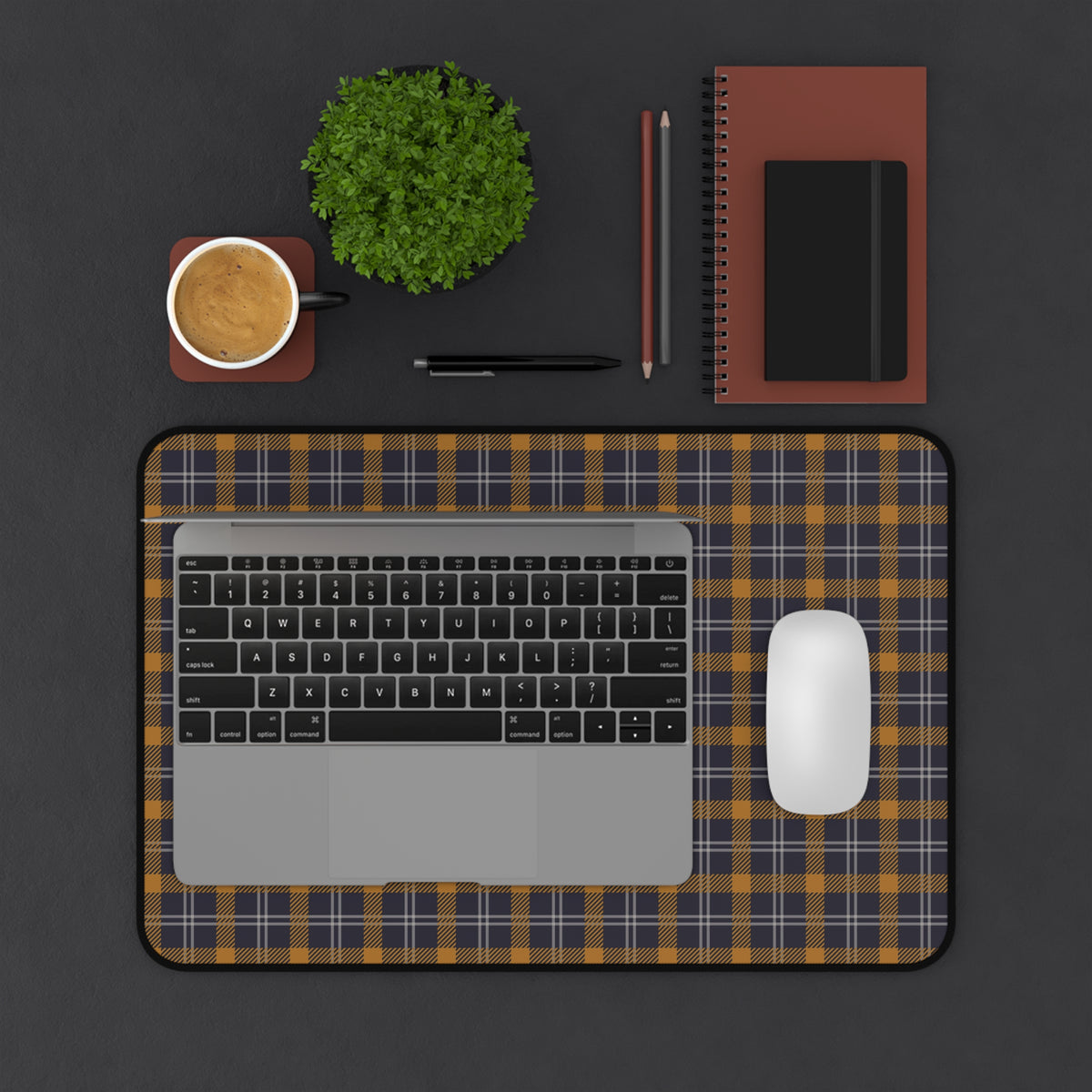 Navy ochre plaid desk mat on a dark desk with laptop, mouse and coffee
