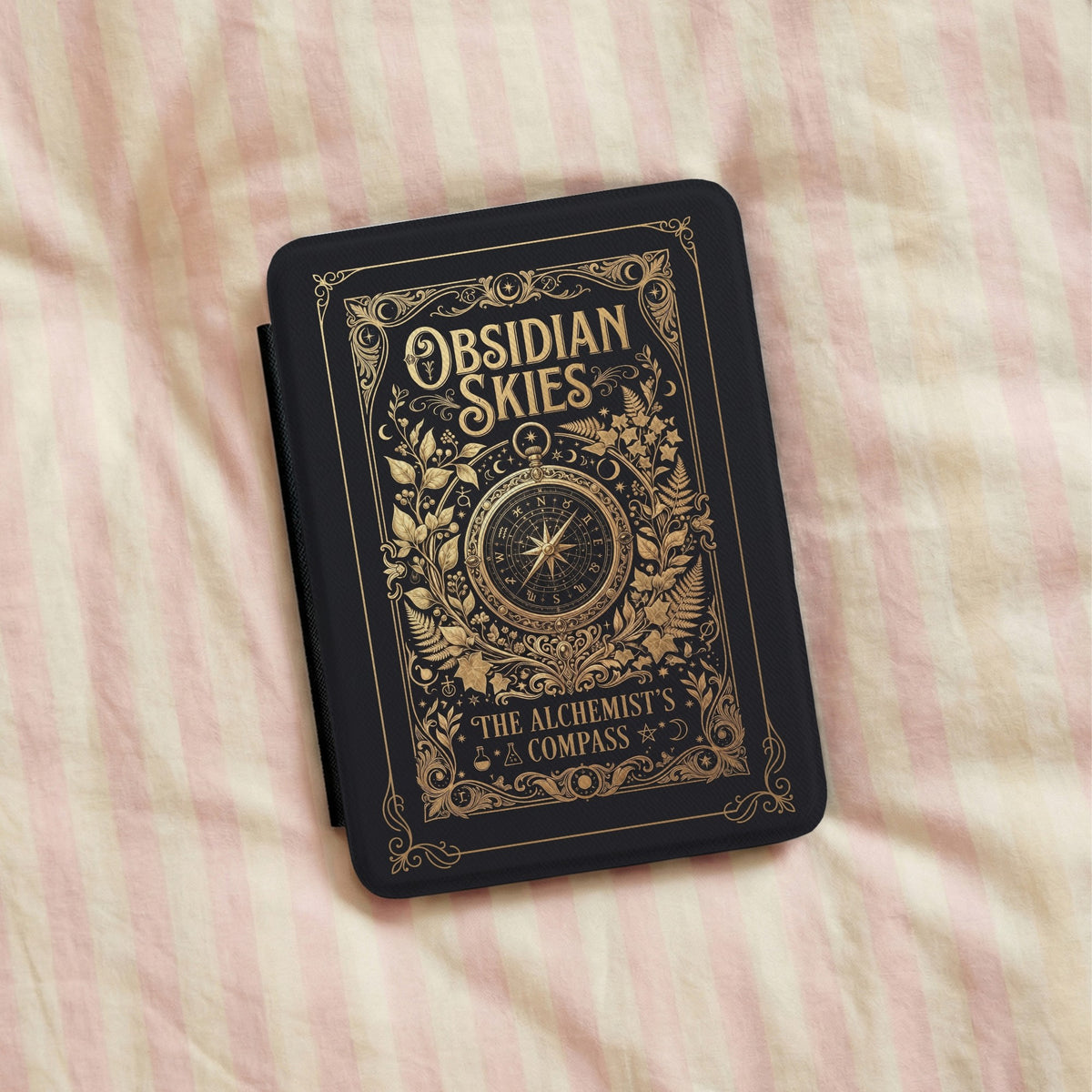 Obsidian Skies Kindle case on striped bedding