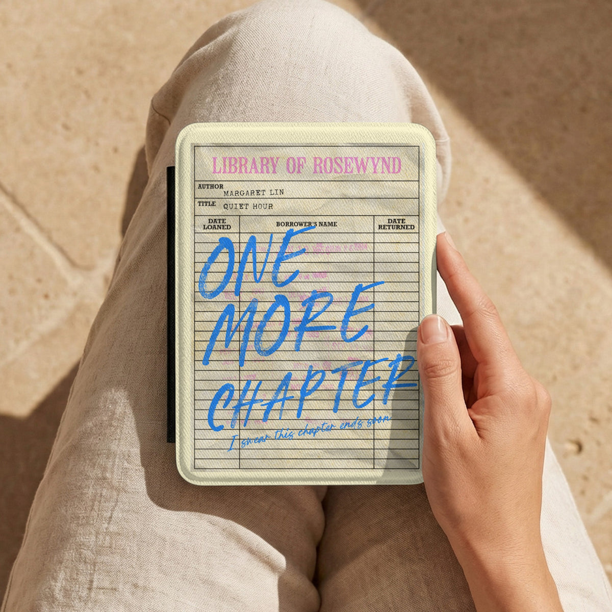 One More Chapter Kindle case held on the lap while reading