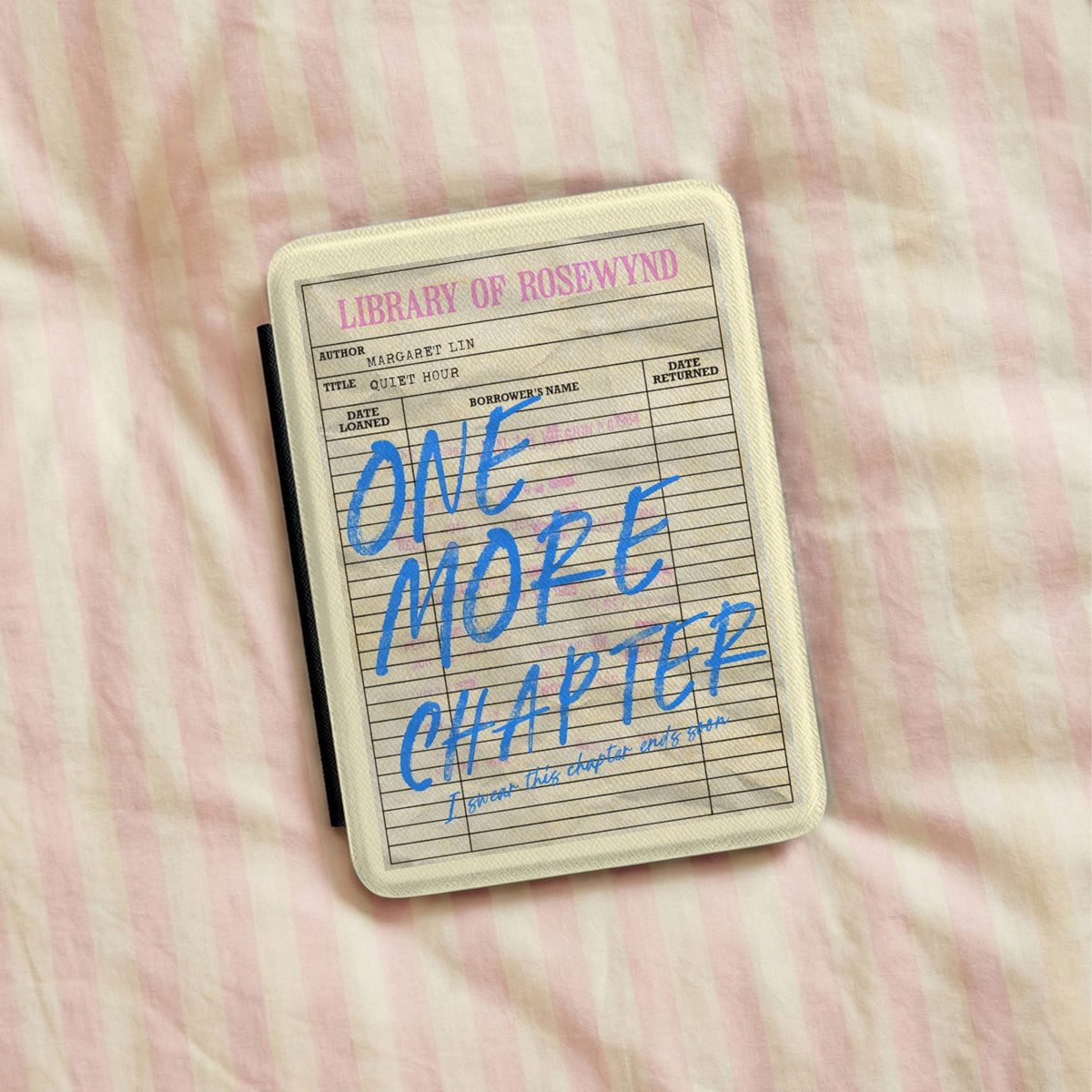 One More Chapter Kindle case lying on pink striped bedding