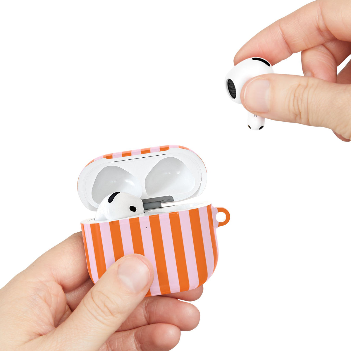Orange Cabana Stripe AirPods case held in hand while taking out an earbud