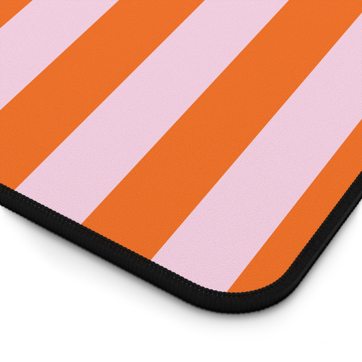 Close-up of the Orange Cabana Stripe desk mat print and stitched edge