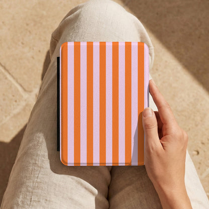 Orange Cabana Stripe Kindle case held on a lap in the sun
