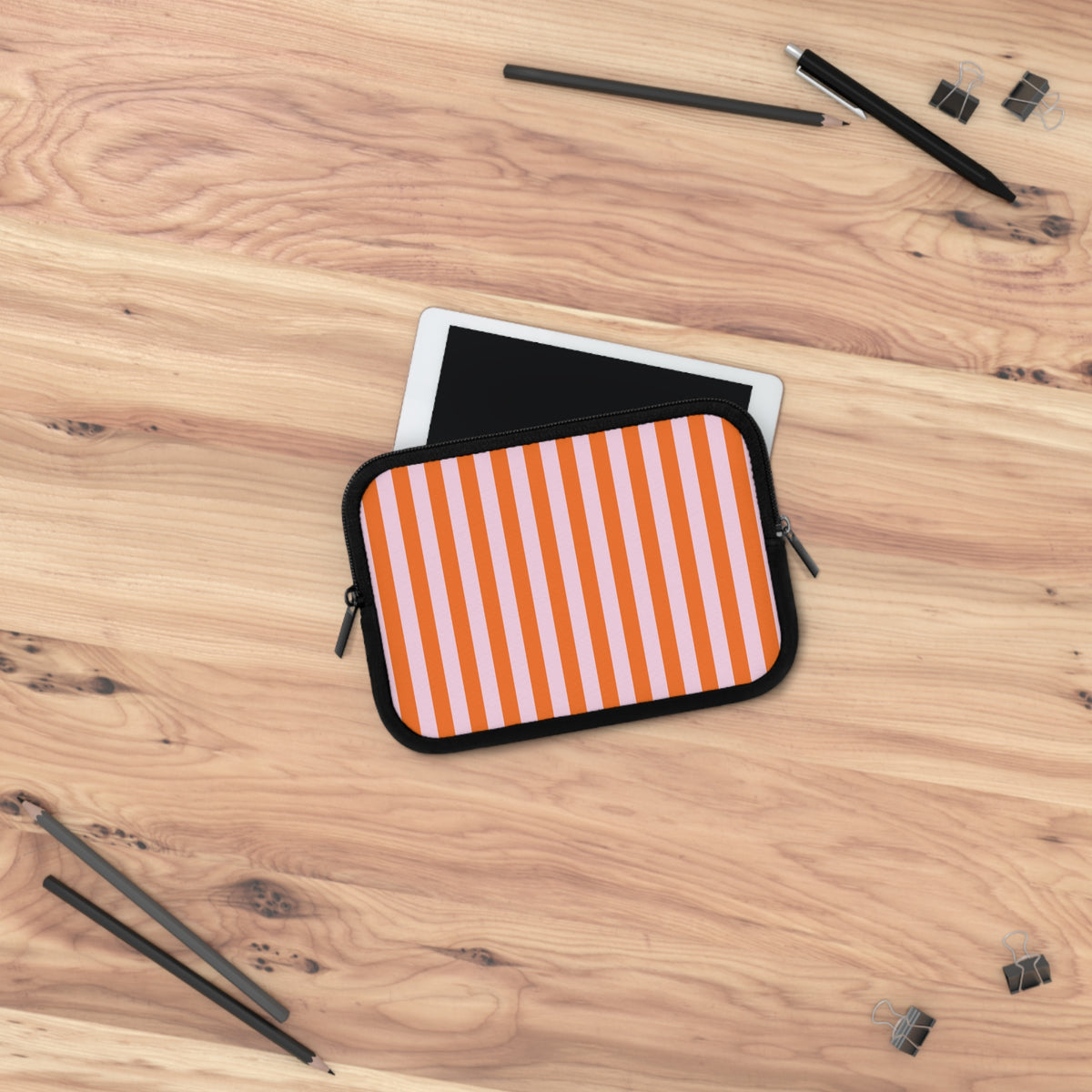 Orange cabana stripe laptop sleeve on a wooden desk with a laptop