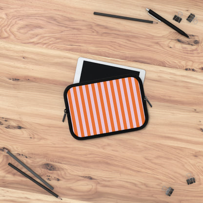 Orange cabana stripe laptop sleeve on a wooden desk with a laptop