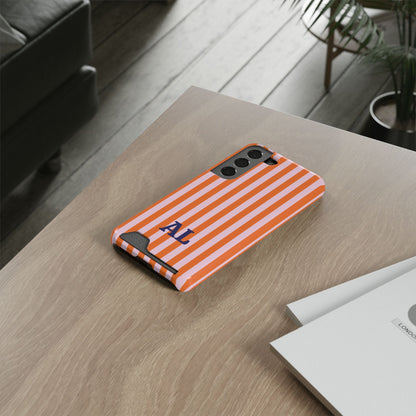 Orange Cabana Stripe card holder phone case on a desk