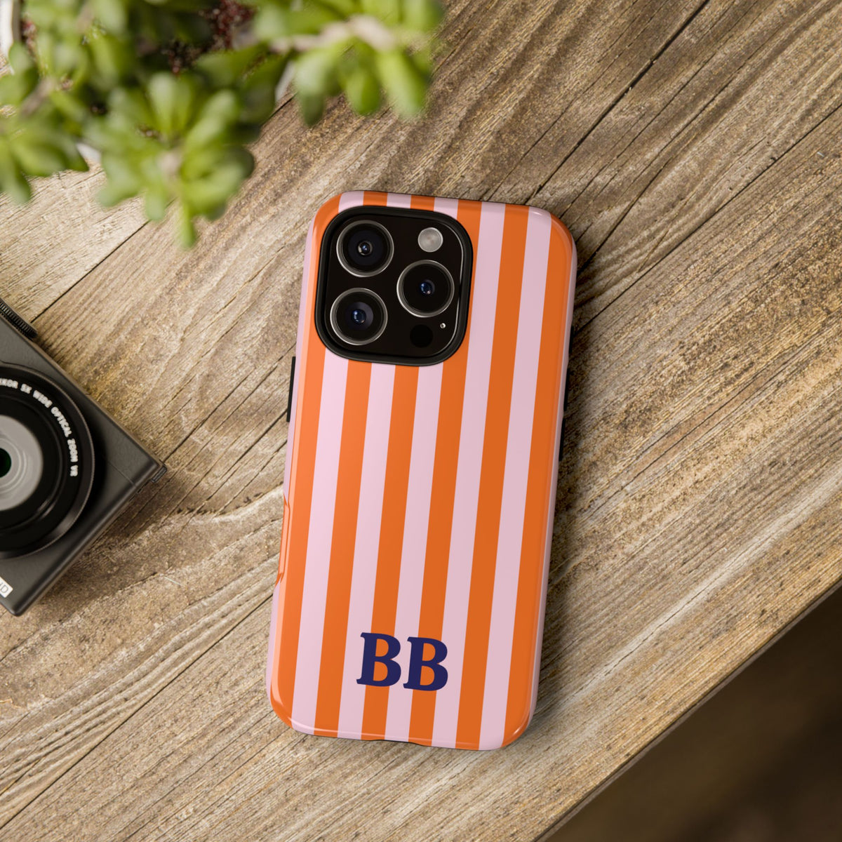 Orange Cabana Stripe tough phone case on a wooden table