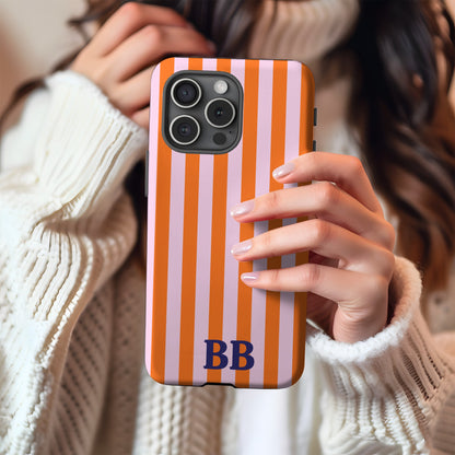 Orange Cabana Stripe tough phone case with BB monogram held in hand