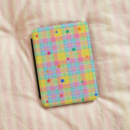 Pastel Plaid Stars Kindle case lying on pink striped bedding