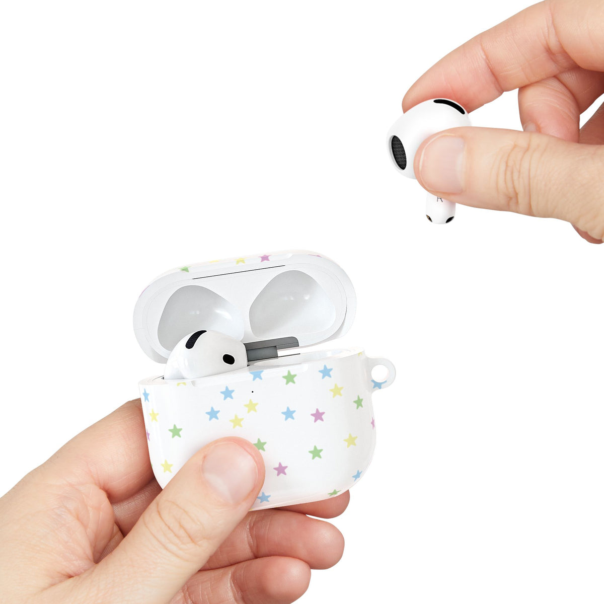 Pastel stars AirPods case held in hand while taking out an AirPod