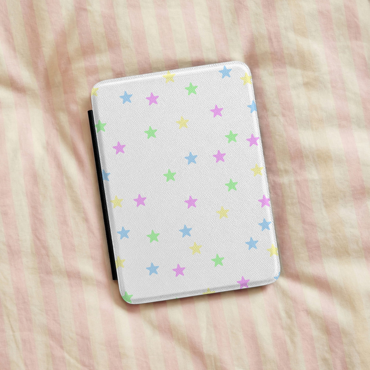 Pastel Stars Kindle case on pink striped linen bedding