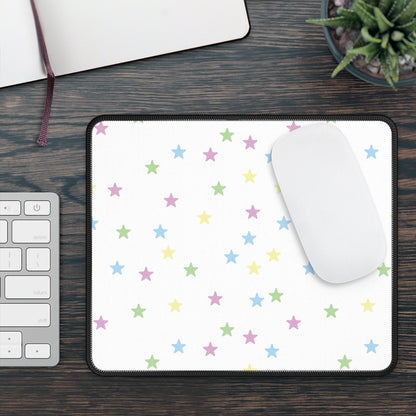 Pastel Stars mouse mat on a wooden desk with a mouse, keyboard and plant