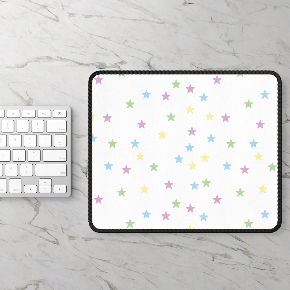 Pastel Stars mouse mat on a marble desk beside a keyboard