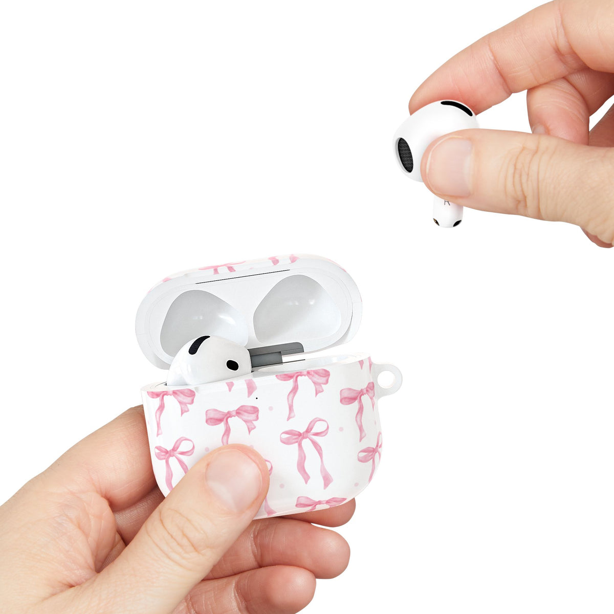 Hand holding the open Pink Bow AirPods case