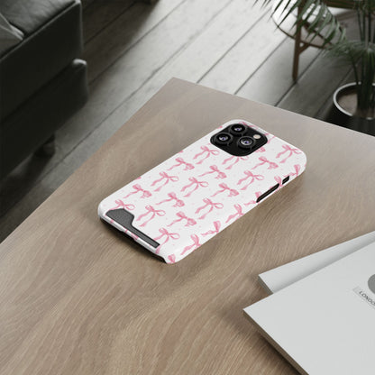 Pink Bow phone case with card holder on a wooden desk