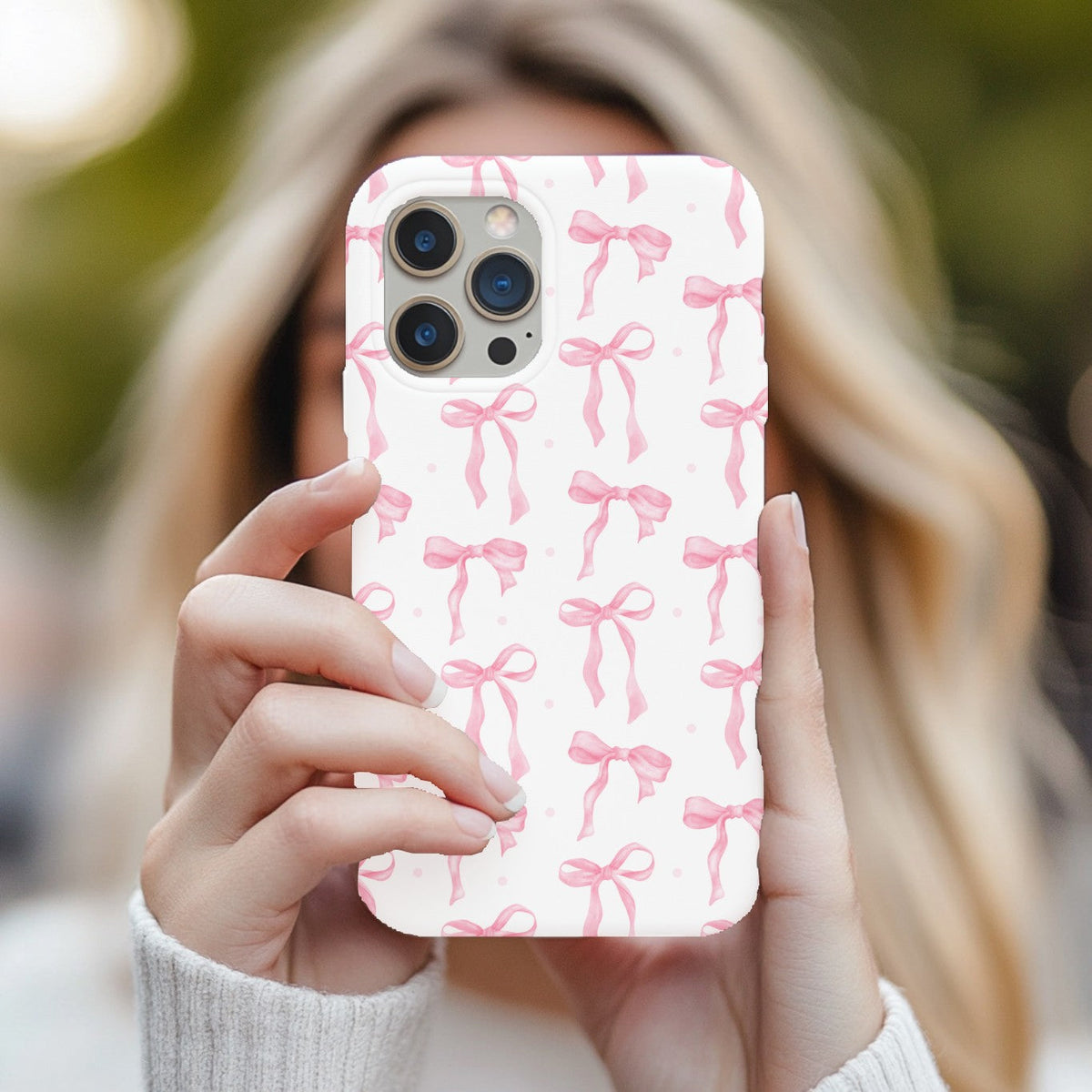 Woman holding a Pink Bow tough phone case