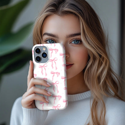 Pink Bow phone case held up beside a face