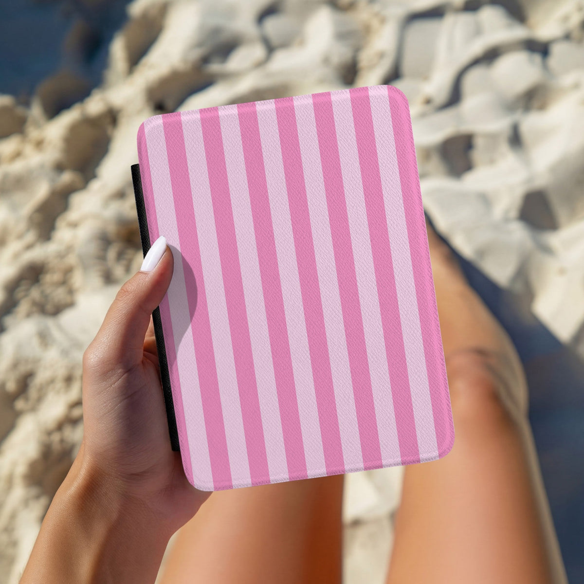 Hands holding a personalised pink cabana stripe Kindle case