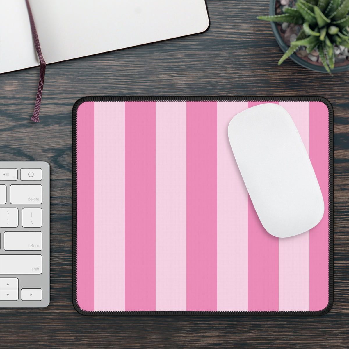 Pink cabana stripe mouse mat on a wooden desk beside a keyboard and mouse