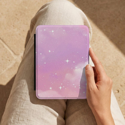 Pink Galaxy Kindle case held on a lap while reading