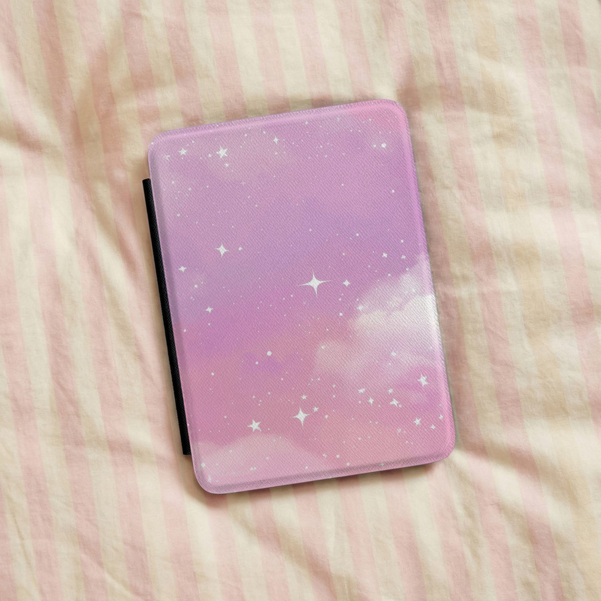 Pink Galaxy Kindle case on pink striped linen bedding