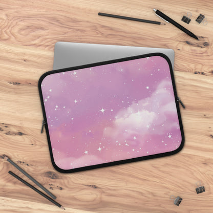 Pink Galaxy laptop sleeve on a wooden desk beside a laptop
