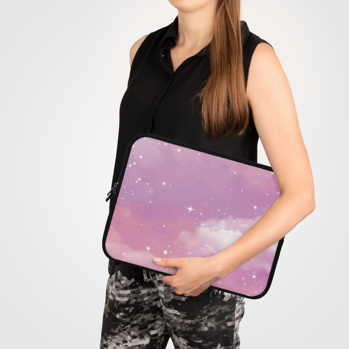 Pink Galaxy laptop sleeve carried under one arm