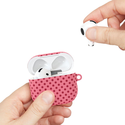 Pink polka dot AirPods case held in hand while taking out an earbud