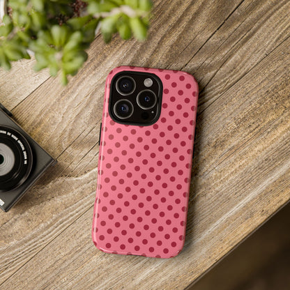 Pink Polka Dot tough phone case on a wooden desk