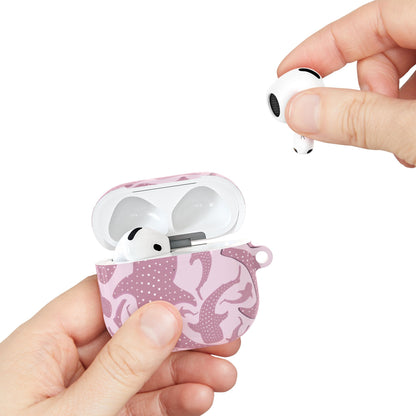 Pink whale shark AirPods case held in hand while taking out an earbud