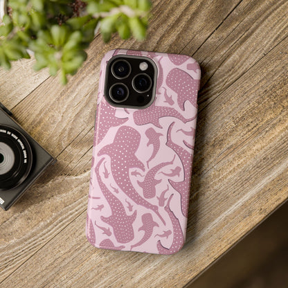 Pink Whale Shark tough magnetic phone case on a wooden table next to a plant