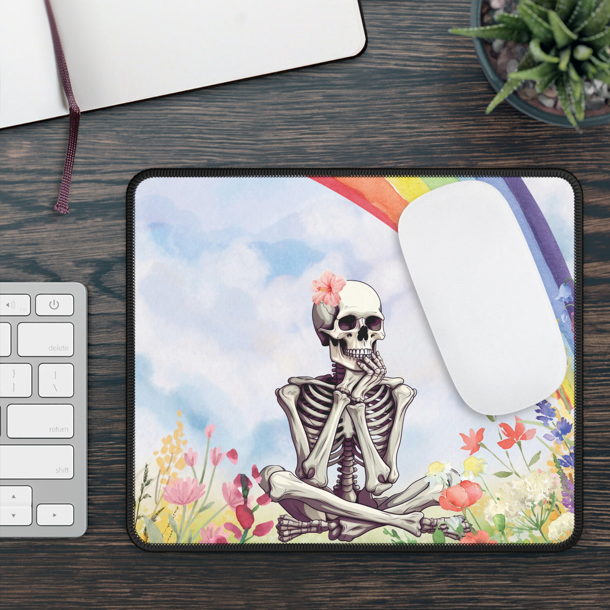 Rainbow Skeleton mouse mat on a desk beside a keyboard and white mouse
