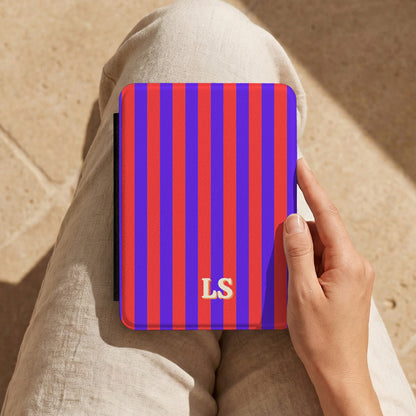 Red Cabana Stripe Kindle case with initials held on the lap