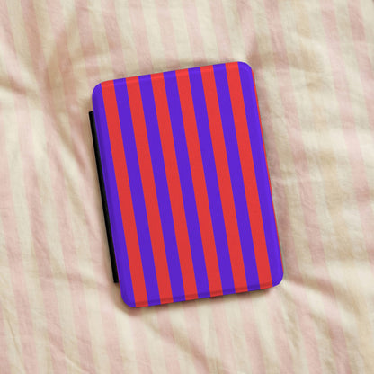 Red Cabana Stripe Kindle case resting on striped bedding