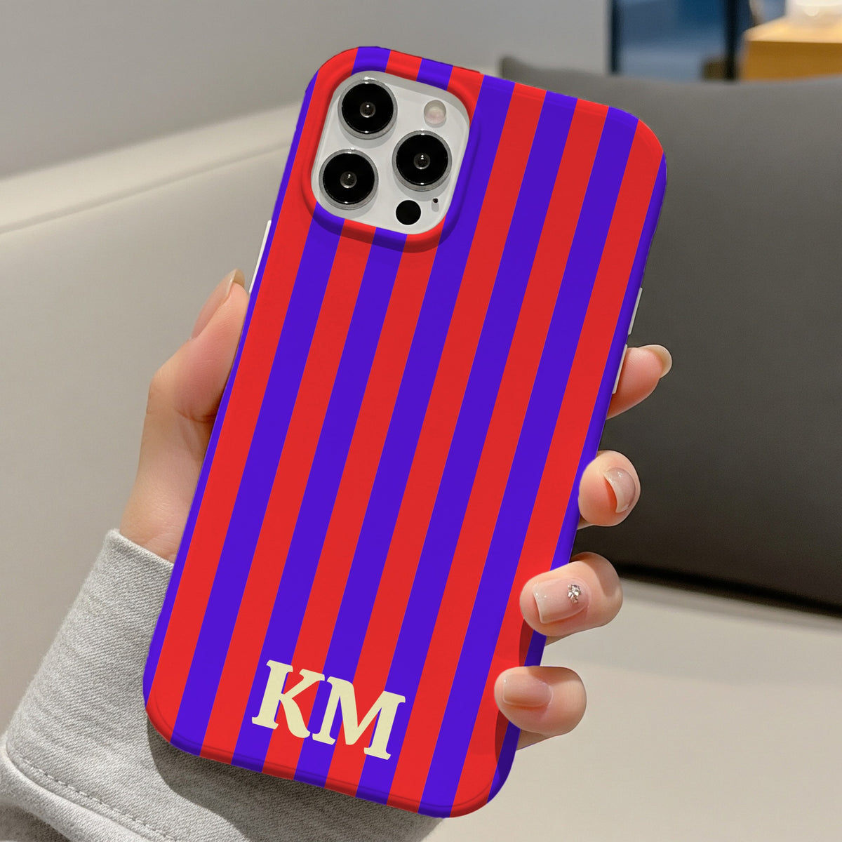 Red Cabana Stripe tough phone case with KM monogram held in hand
