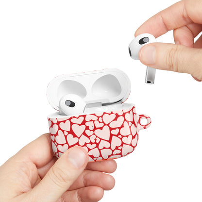 Red hearts AirPods case held in hand while taking out an earbud