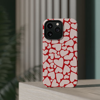 Red Hearts MagSafe phone case on a phone standing on a wooden shelf