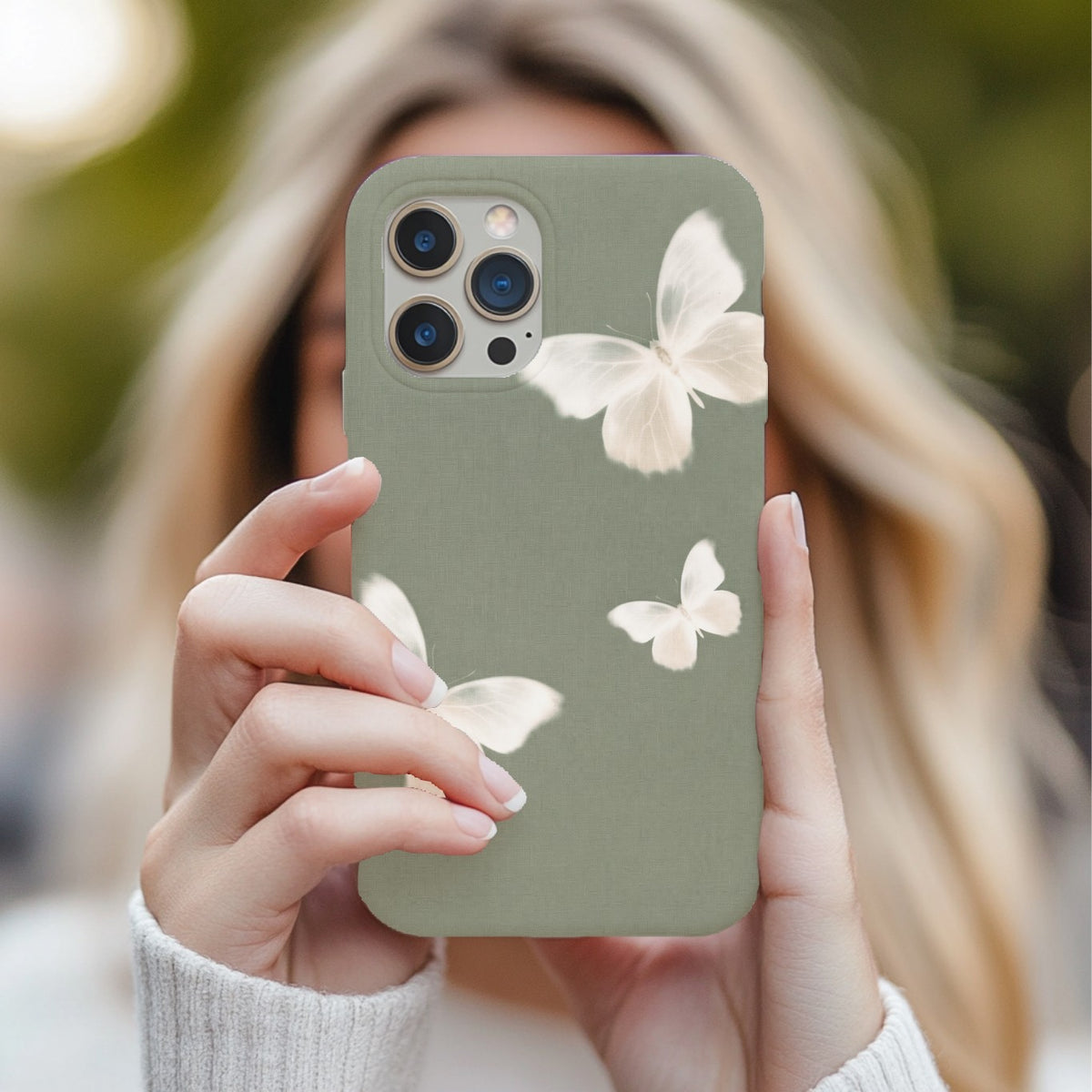 Sage Butterfly tough phone case held up in front of a face