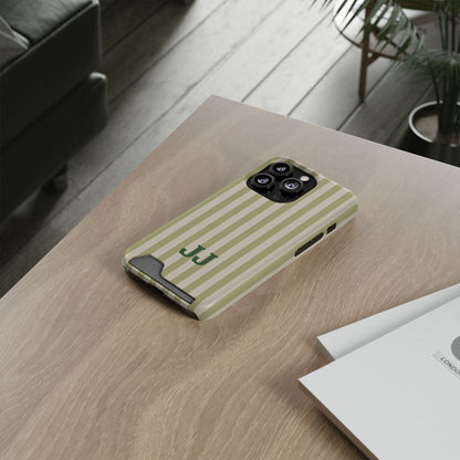 Sage Cabana Stripe card holder phone case on a wooden desk