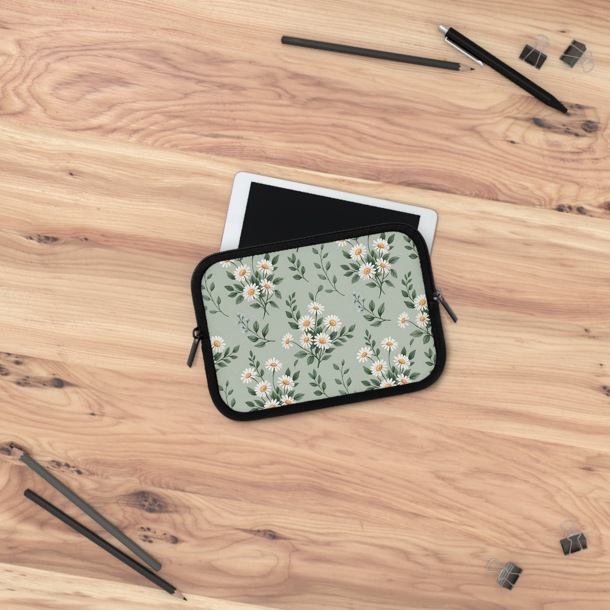 Sage Daisy laptop sleeve on a wooden desk next to a tablet