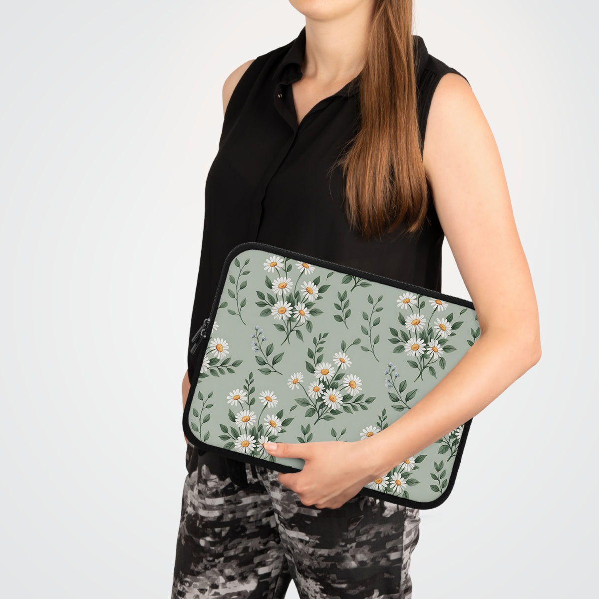 Sage Daisy laptop sleeve carried under the arm