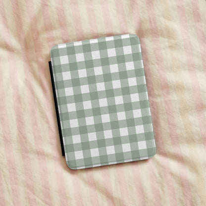 Sage Gingham Kindle case lying on pink striped bedding